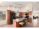Charming kitchen with wood cabinets, island with seating, modern black appliances, and tile flooring at 1523 E Tulsa St, Chandler, AZ 85225