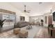Bright living room featuring vaulted ceiling, ceiling fan, neutral walls and flooring, and lots of natural light at 1523 E Tulsa St, Chandler, AZ 85225