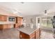 Open living space with custom built-ins, kitchen island, vaulted ceiling, tile flooring, and backyard access at 1523 E Tulsa St, Chandler, AZ 85225