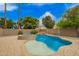 Beautiful backyard pool and spa area surrounded by mature landscaping and stone features at 1523 E Tulsa St, Chandler, AZ 85225