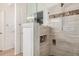 Tiled shower with decorative tile work, built-in storage and a glass enclosure at 1523 E Tulsa St, Chandler, AZ 85225