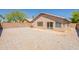 View of the home's back exterior featuring a patio and gravel landscaping at 15642 N Naegel Dr, Surprise, AZ 85374