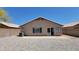 Backyard view featuring the home's rear facade with a patio area, windows, and an AC unit at 15642 N Naegel Dr, Surprise, AZ 85374