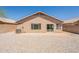 Home back exterior featuring a patio, gravel landscaping, and an AC unit at 15642 N Naegel Dr, Surprise, AZ 85374