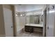 Clean bathroom with a vanity, large mirror, and a shower-tub combination at 15642 N Naegel Dr, Surprise, AZ 85374