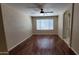 Large bedroom featuring wood floors, a ceiling fan, and natural light at 15642 N Naegel Dr, Surprise, AZ 85374