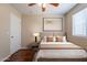 Modern staged bedroom with wood floors, a large window and neutral walls at 15642 N Naegel Dr, Surprise, AZ 85374