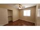 Comfortable bedroom with a closet, ceiling fan, and a window for natural light at 15642 N Naegel Dr, Surprise, AZ 85374