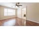 Large bedroom with wood flooring, a ceiling fan, and ensuite bathroom creating a relaxing, private space at 15642 N Naegel Dr, Surprise, AZ 85374