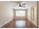 This bright, open bedroom offers wood floors and a large window offering relaxing, natural light at 15642 N Naegel Dr, Surprise, AZ 85374