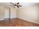 Spacious bedroom with wood floors and a ceiling fan at 15642 N Naegel Dr, Surprise, AZ 85374