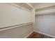 Walk-in closet with white shelving and wooden floors, offering ample storage space at 15642 N Naegel Dr, Surprise, AZ 85374