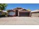 Charming single-story home with a well-maintained front yard and two car garage at 15642 N Naegel Dr, Surprise, AZ 85374