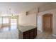 Open-concept kitchen features tile floors, granite center island, and backyard access at 15642 N Naegel Dr, Surprise, AZ 85374