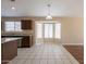 Spacious open-concept kitchen boasts tile floors, granite countertops, and stainless appliances at 15642 N Naegel Dr, Surprise, AZ 85374
