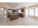 Open concept kitchen with center island, stainless appliances, and tile flooring at 15642 N Naegel Dr, Surprise, AZ 85374