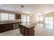 Well-lit open-concept kitchen featuring granite countertops, center island, and ample natural light at 15642 N Naegel Dr, Surprise, AZ 85374