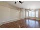 Open living room features beautiful wood floors, neutral walls, and plenty of natural light at 15642 N Naegel Dr, Surprise, AZ 85374