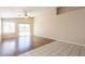 Bright living room features wood floors, ceiling fan and sliding glass doors to let in plenty of natural light at 15642 N Naegel Dr, Surprise, AZ 85374