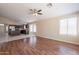 This expansive living area features wood floors and opens into the kitchen with stainless steel appliances at 15642 N Naegel Dr, Surprise, AZ 85374