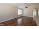 Spacious living room featuring hardwood floors, neutral walls, ceiling fan, and natural light at 15642 N Naegel Dr, Surprise, AZ 85374
