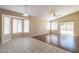 Bright living room featuring tile and laminate flooring, natural light, and backyard access at 15642 N Naegel Dr, Surprise, AZ 85374