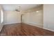 Large living room with hardwood floors, neutral walls, ceiling fan, and recessed lighting at 15642 N Naegel Dr, Surprise, AZ 85374