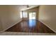 Bright living room featuring wood floors, large windows, and a sliding door to the back at 15642 N Naegel Dr, Surprise, AZ 85374
