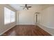 Bright living room with hardwood floors, neutral walls, large windows, and an open floor plan at 15642 N Naegel Dr, Surprise, AZ 85374