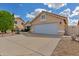 Single-story home featuring a neutral color scheme, tile roof, desert landscaping, and a two-car garage at 16230 E Glenpoint Dr, Fountain Hills, AZ 85268