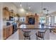 This home features a well-lit kitchen with granite countertops and black appliances with a view to the dining area at 16230 E Glenpoint Dr, Fountain Hills, AZ 85268