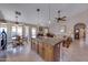 Open concept kitchen island with bar seating, granite countertops, with a view to the living and dining area at 16230 E Glenpoint Dr, Fountain Hills, AZ 85268