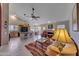 Open-concept living space with fireplace, comfortable furniture, and seamless flow to the kitchen and dining areas at 16230 E Glenpoint Dr, Fountain Hills, AZ 85268