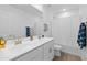 Bathroom boasting double vanity sinks, neutral colors and a shower-tub combo at 16956 W Alice Ave, Waddell, AZ 85355