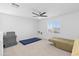 Bright bedroom with a ceiling fan, carpet flooring and a window overlooking the neighborhood at 16956 W Alice Ave, Waddell, AZ 85355