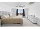 Bright bedroom with a large window, ceiling fan, and neutral carpet at 16956 W Alice Ave, Waddell, AZ 85355