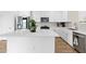 Kitchen featuring white cabinets, a center island, and stainless steel appliances at 16956 W Alice Ave, Waddell, AZ 85355