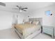 Spacious main bedroom featuring carpet, ceiling fan, bright windows and neutral paint at 16956 W Alice Ave, Waddell, AZ 85355