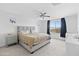 Spacious main bedroom with carpet, ceiling fan and bright windows overlooking trees at 16956 W Alice Ave, Waddell, AZ 85355