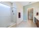 Bright bathroom with a glass enclosed shower and convenient access to a walk-in closet at 17192 W Hermosa Dr, Surprise, AZ 85387