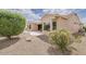 This home boasts attractive desert landscaping with flowering bushes and a peaceful patio at 17192 W Hermosa Dr, Surprise, AZ 85387