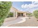 A view of the beautiful backyard with a patio, desert landscaping, and a charming walkway at 17192 W Hermosa Dr, Surprise, AZ 85387