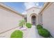 Inviting front entrance with stone pathway, decorative shrubs, and covered alcove at 17192 W Hermosa Dr, Surprise, AZ 85387