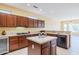 Well-lit kitchen featuring granite countertops, stainless appliances, an island, and custom cabinets at 17192 W Hermosa Dr, Surprise, AZ 85387