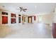Spacious living room featuring tile floors, a ceiling fan, and built in display shelving at 17192 W Hermosa Dr, Surprise, AZ 85387