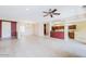 Open concept living room featuring tile floors, a ceiling fan, and natural light at 17192 W Hermosa Dr, Surprise, AZ 85387
