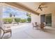This covered patio is perfect for outdoor dining and relaxation with views of the landscaped backyard at 17192 W Hermosa Dr, Surprise, AZ 85387