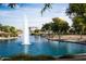 Beautiful water feature of the community pond with a fountain and mature trees at 17192 W Hermosa Dr, Surprise, AZ 85387