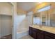 Well-lit bathroom with a shower-tub combination and dark wood vanity at 18250 N 32Nd St # 1019, Phoenix, AZ 85032