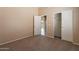 Neutral bedroom with a closet, doorways to other rooms, and carpeted floor at 18250 N 32Nd St # 1019, Phoenix, AZ 85032